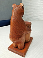 Vintage Russian folk art bear showing wood grain and patina