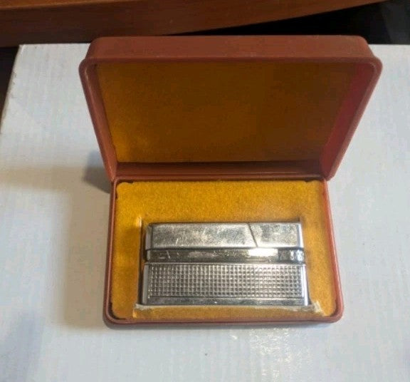 Soviet ZG20 gas lighter with textured lattice body and original brown plastic case