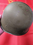 WWII Soviet helmet showing marks and scratches on the shell