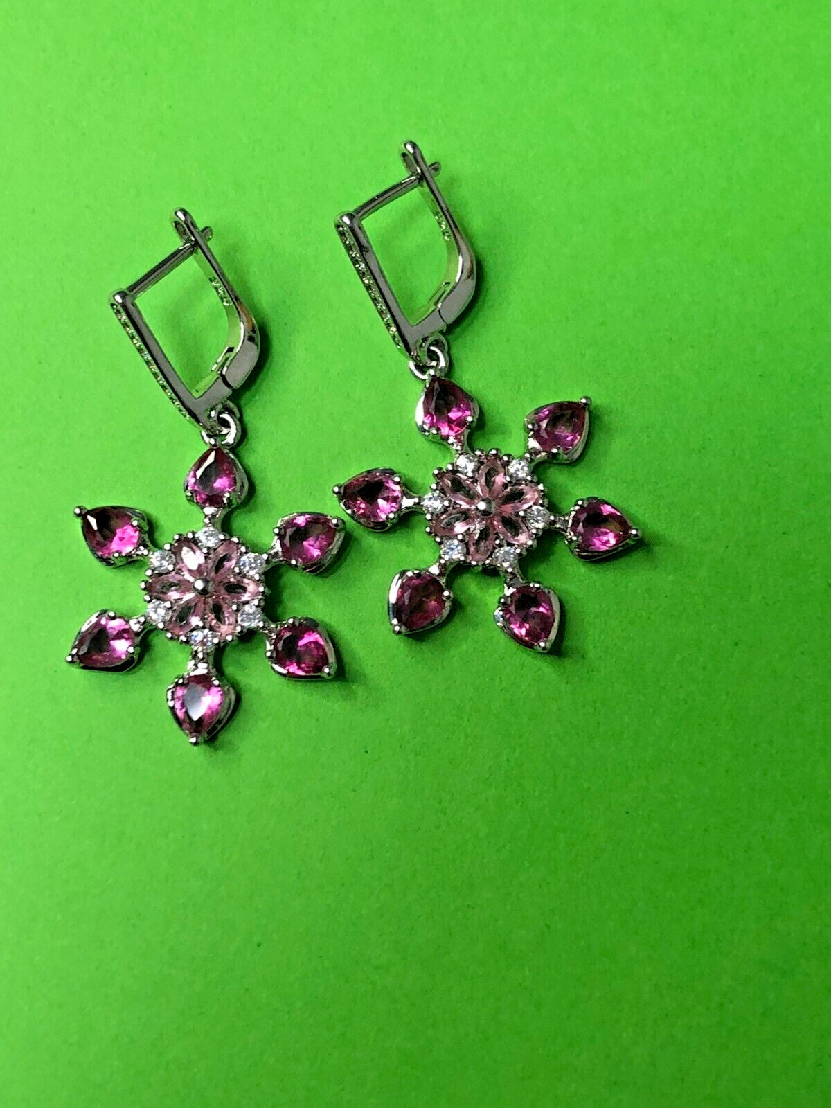 Sterling silver snowflake drop earrings with pink stones and leverback closure