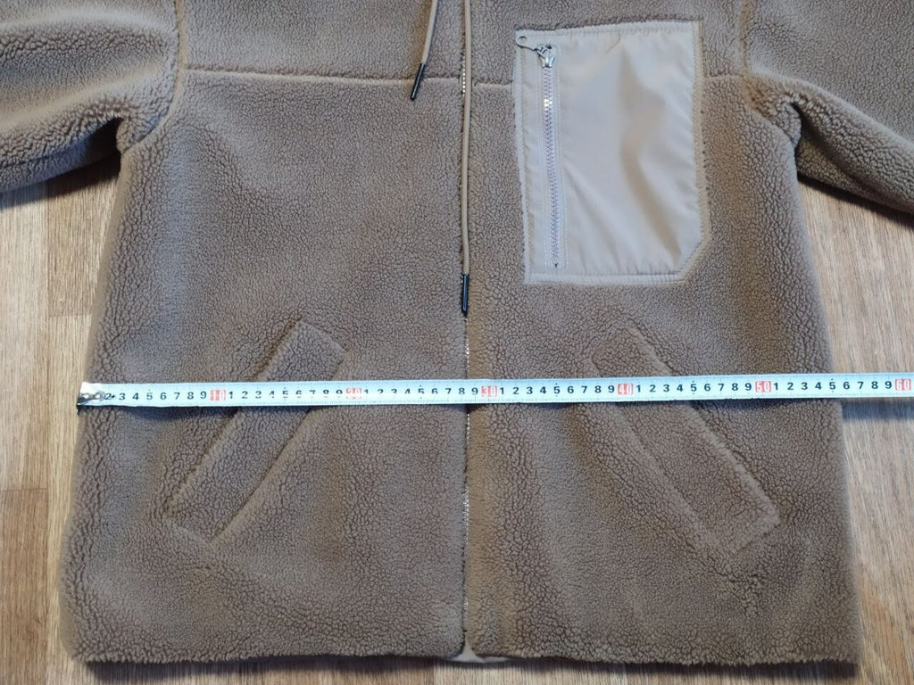 Kids teddy coat laid flat with measuring tape across the chest – detail 12