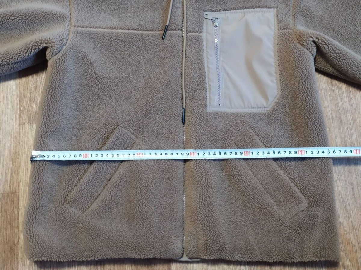 Kids teddy coat laid flat with measuring tape across the chest – detail 12