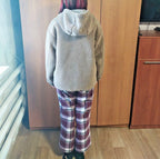 Kids teddy coat laid flat with measuring tape across the chest