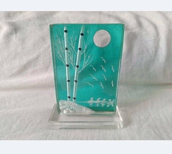 Studio art glass plaque with birch trees and full moon on a teal glass panel with clear stand