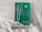 Glass tabletop sculpture in turquoise with full moon and flying birds