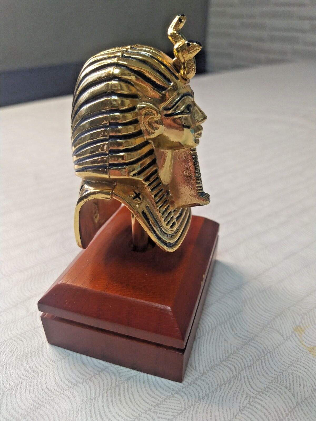 Gold-tone Egyptian pharaoh mask figurine with black recessed accents