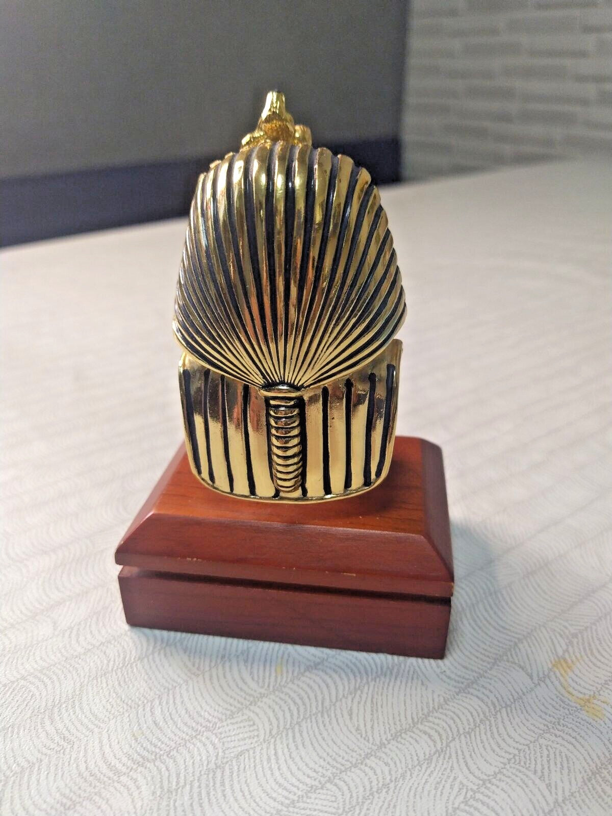 Pharaoh bust mounted on a solid rectangular wooden base