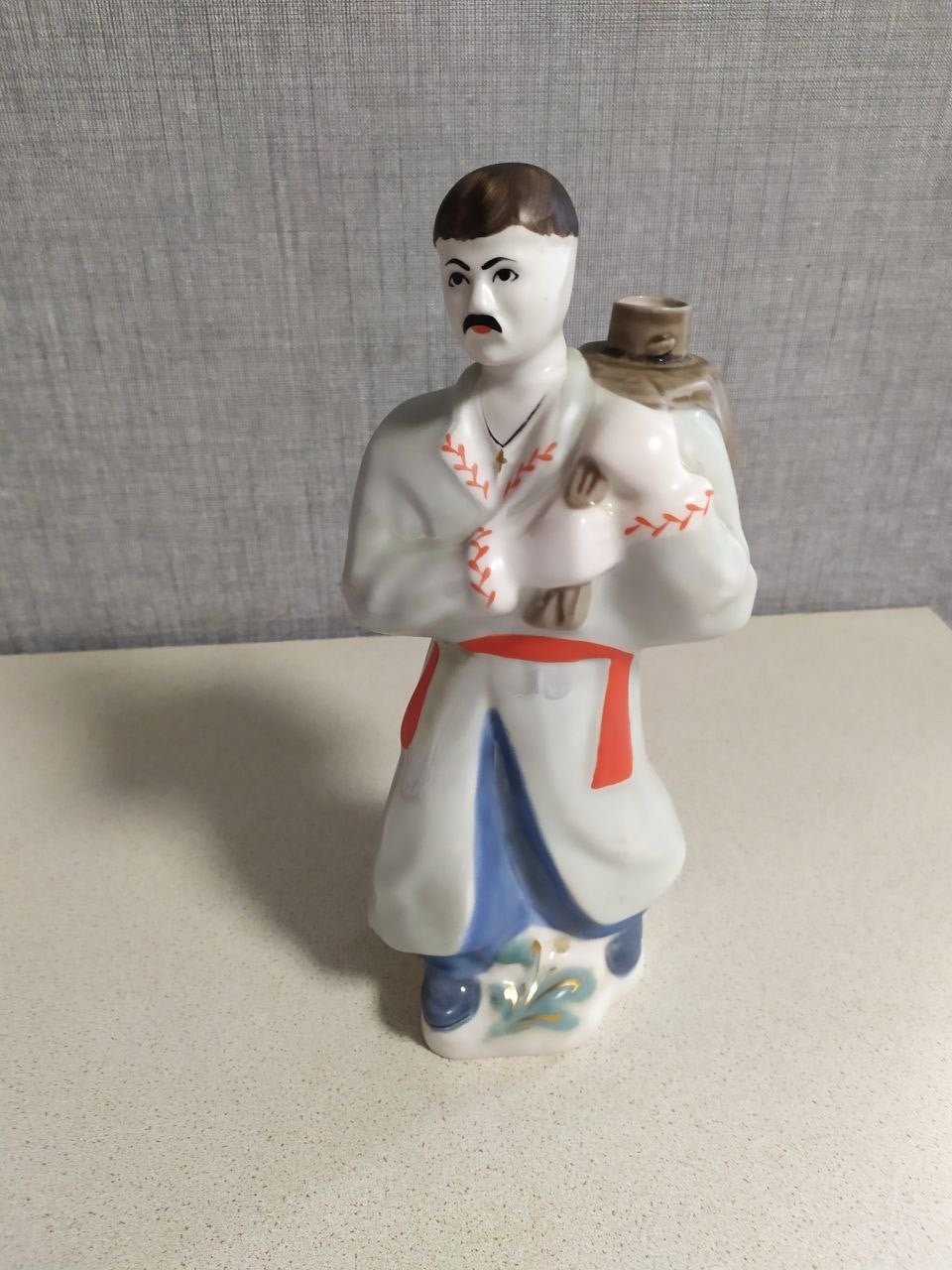 Ukrainian Cossack porcelain decanter shaped as a Kozak in vyshyvanka and blue sharovary