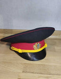 Ukrainian militia visor cap in dark blue with red band and Tryzub metal cockade