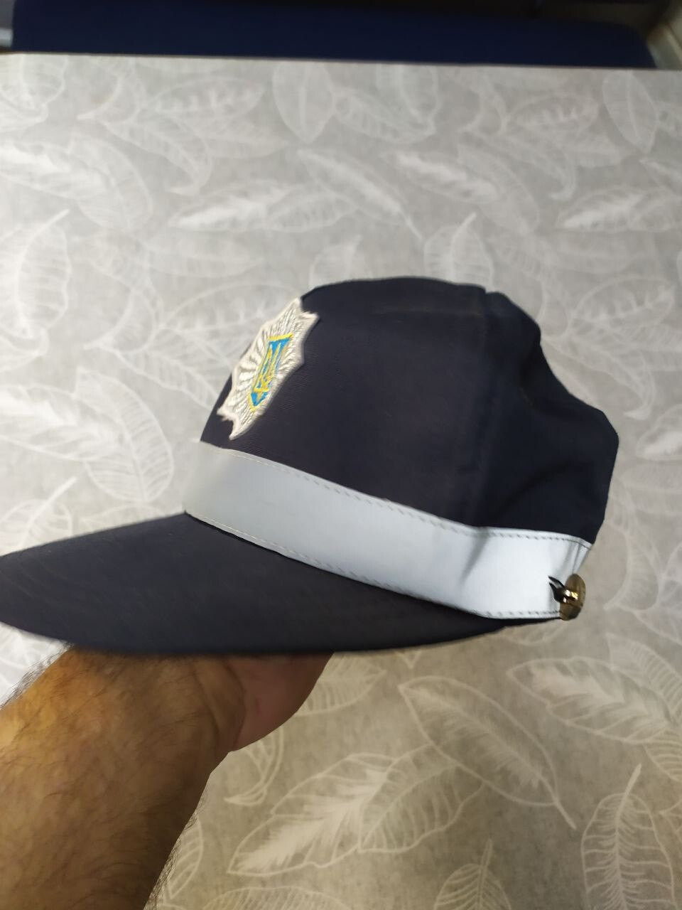 Embroidered silver star with Tryzub on the National Police of Ukraine cap