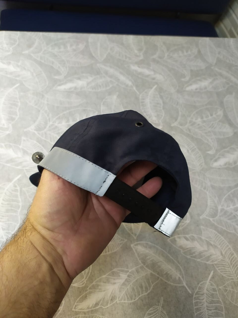 Reflective grey band around the crown of the police uniform hat