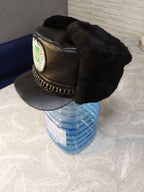 Embroidered Tryzub patch with silver-tone wreath on the winter uniform hat
