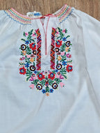 Vyshyvanka laid flat with measuring tape – detail 7