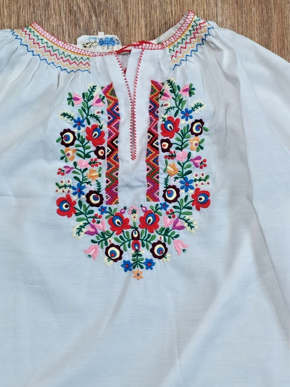 Vyshyvanka laid flat with measuring tape – detail 7