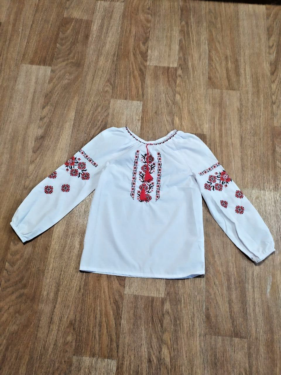 Ukrainian embroidered blouse neckline with red tassels