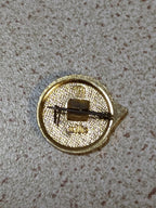 Soviet October Revolution pin photographed on a plain background