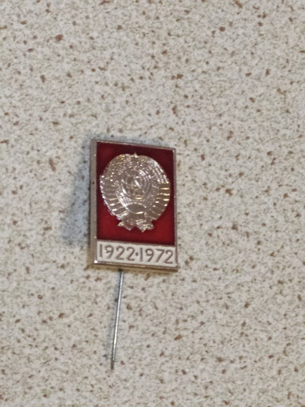 Soviet state emblem pin marking 1922-1972 on a plain background
