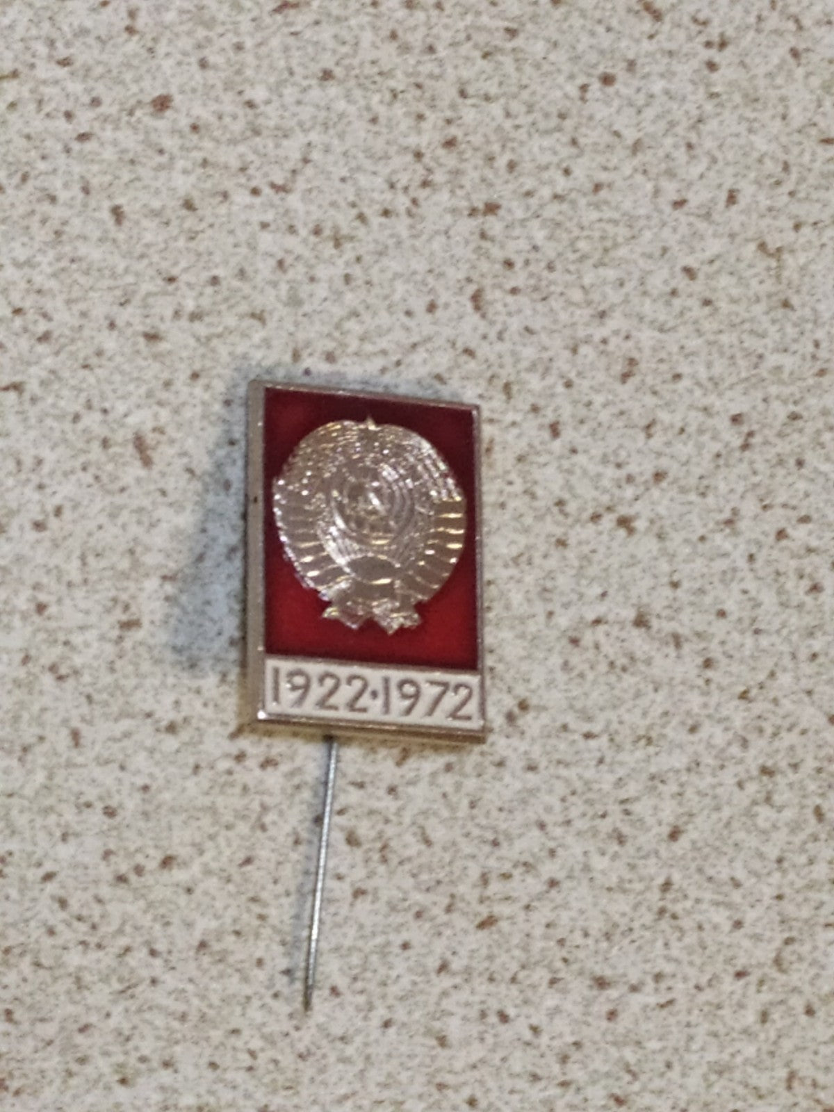 Soviet state emblem pin marking 1922-1972 on a plain background