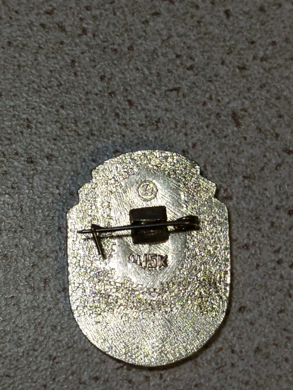 Old Soviet anniversary pin badge shown for scale