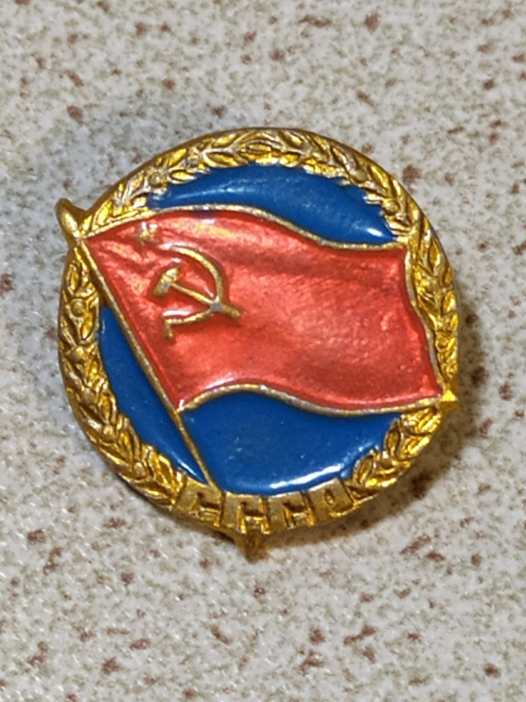 USSR badge pin with hammer and sickle flag on blue background and gold wreath
