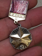 Vintage VLKSM Komsomol award pin on plain background