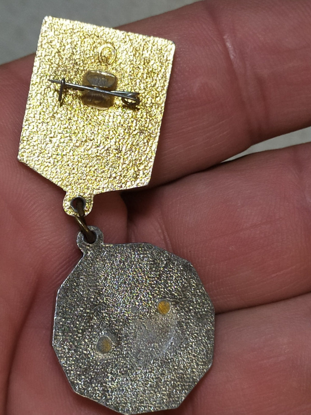 Reverse of the 1st class Komsomol badge with fitting