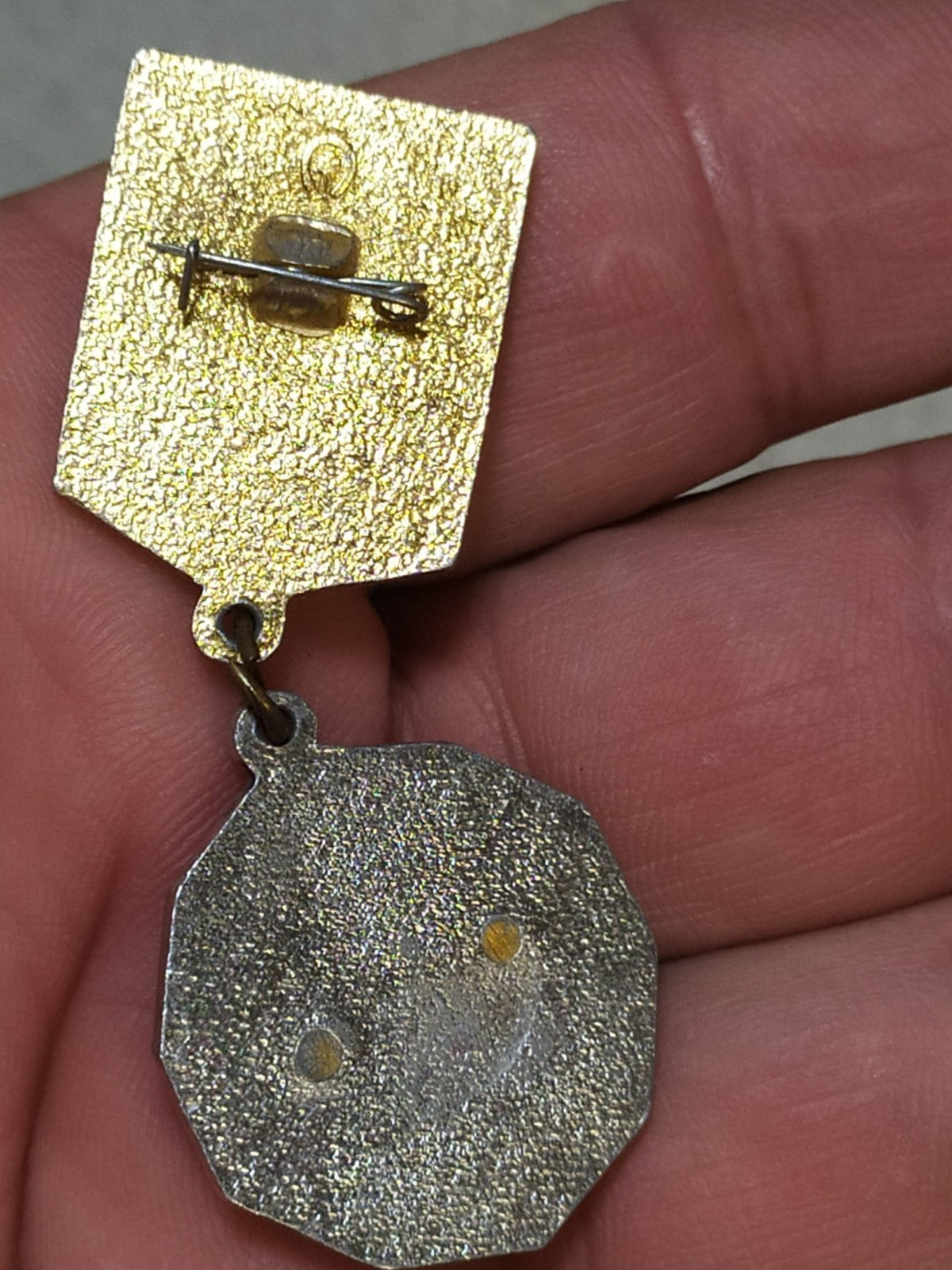 Reverse of the 1st class Komsomol badge with fitting