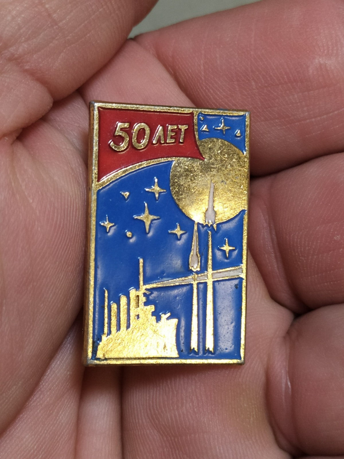 Vintage USSR space exploration pin on plain background