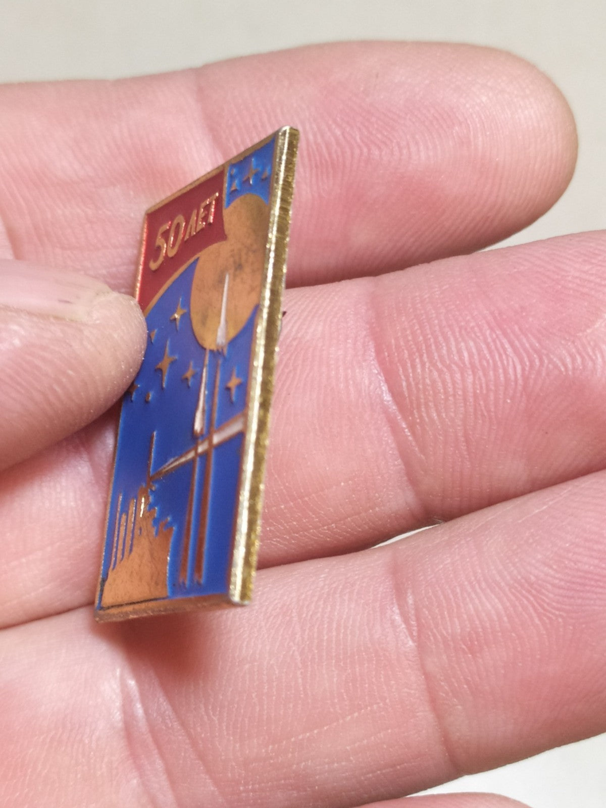 Reverse of old Soviet rocket and cruiser pin
