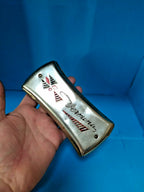 Pocket-size East German Vermona harmonica shown against a hand for scale – detail 13