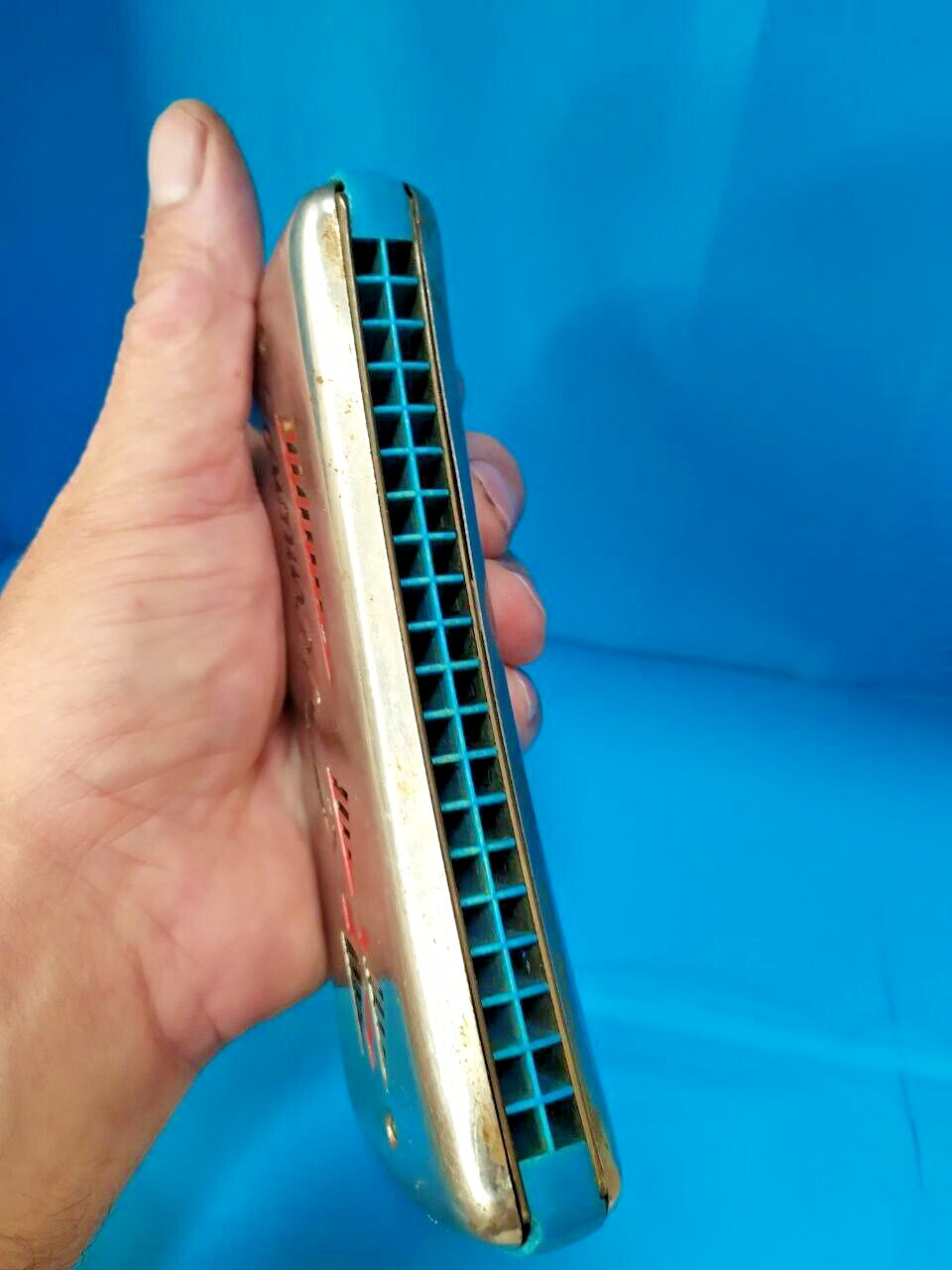 GDR Vermona harmonica with red and black logo and geometric cutouts on chrome covers – detail 17