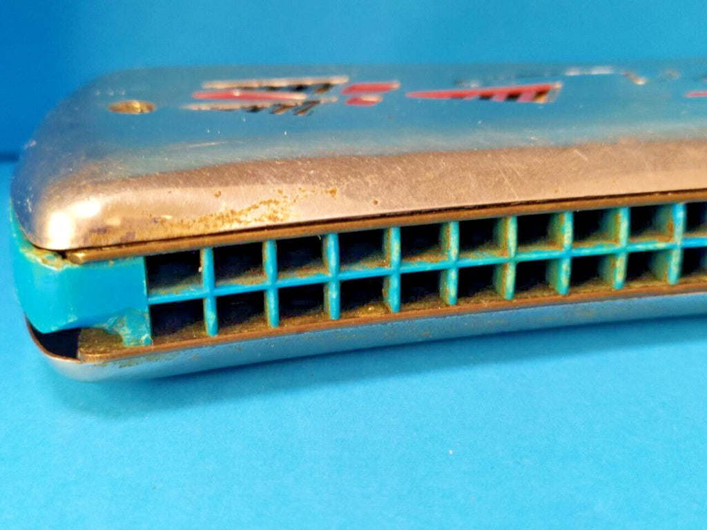 Blue plastic comb of the double-sided tremolo harmonica with small corner chip