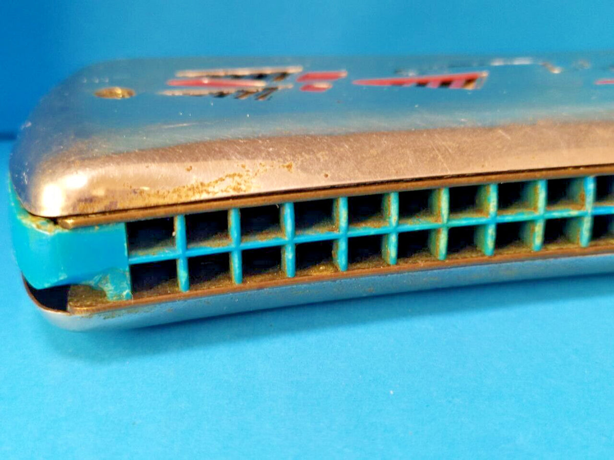 Blue plastic comb of the double-sided tremolo harmonica with small corner chip