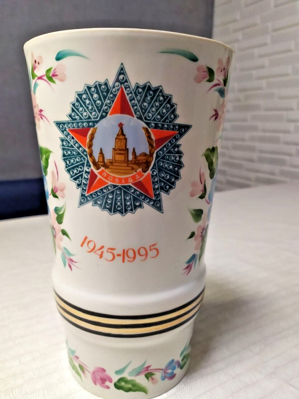 Hand-painted floral pattern and gold banding on the porcelain vase