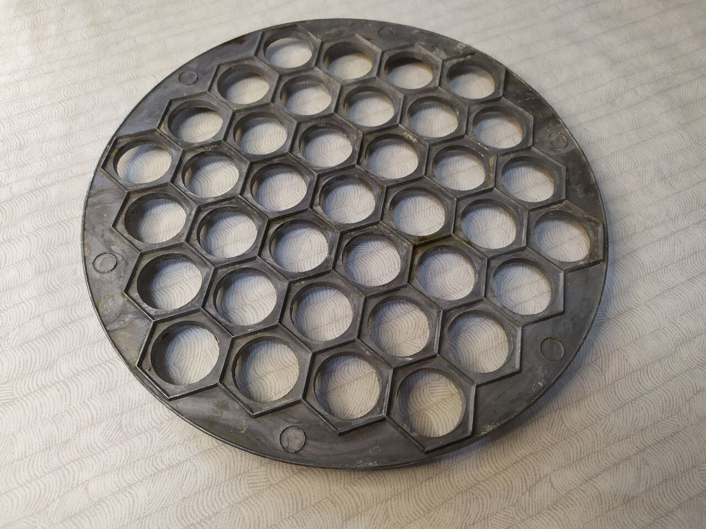Aluminum Ukrainian dumpling maker mold seen from above