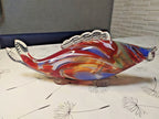 Glass fish figurine side view standing on two glass fin feet