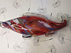 Murano style glass fish close-up of red, blue, yellow and green swirls