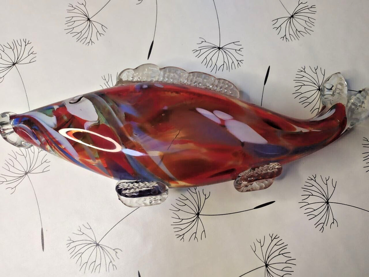 Murano style glass fish close-up of red, blue, yellow and green swirls