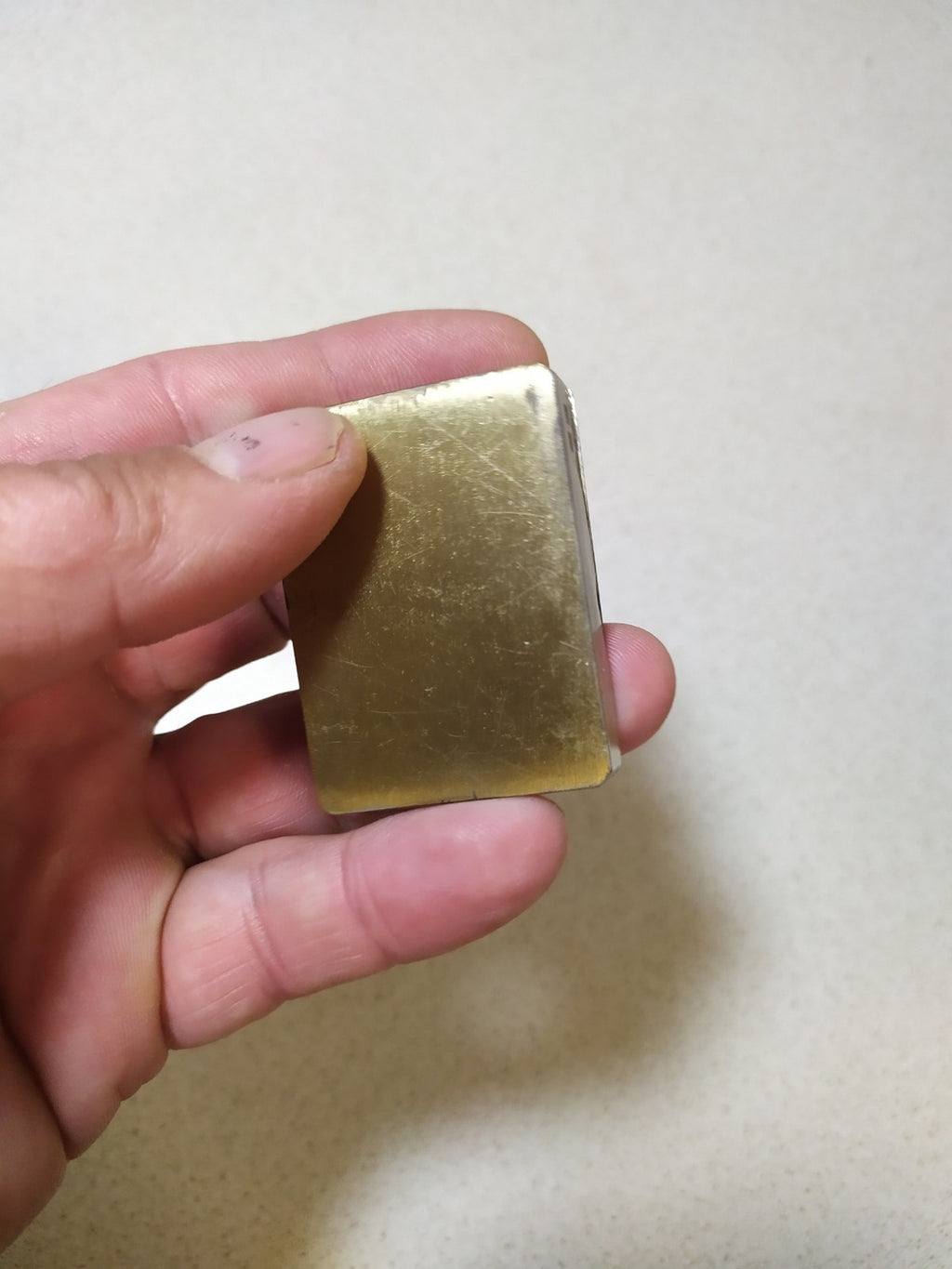 Brass torch lighter with raised trident on the front plate