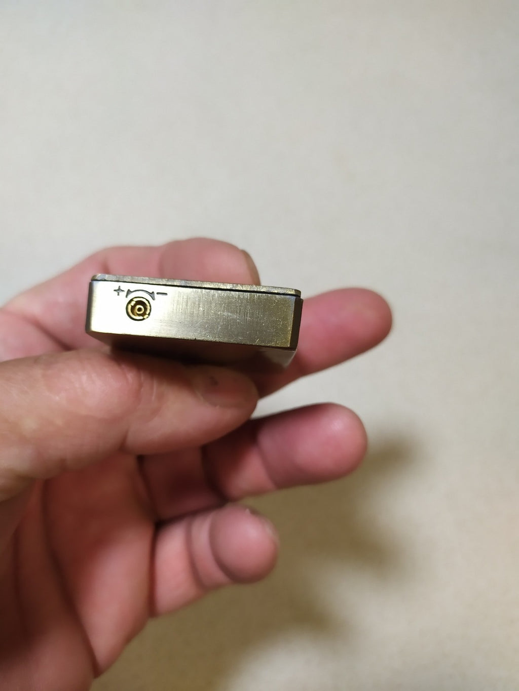 Back of the vintage gas lighter with smooth brass and vent holes