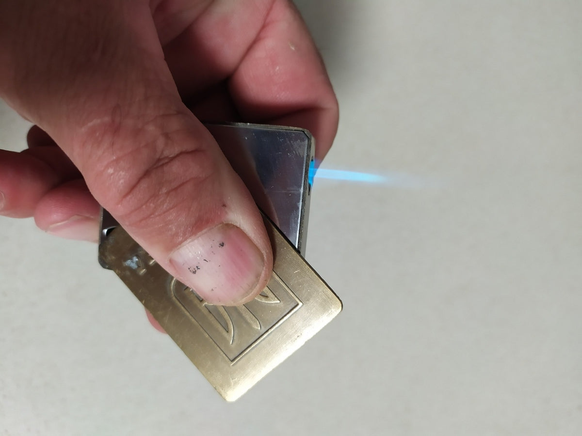 Back of the vintage gas lighter with smooth brass and vent holes – detail 6