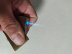 Lighter bottom showing refill valve and flame adjustment screw – detail 7