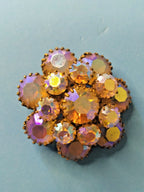 Aurora borealis brooch central rhinestone and accent crystals close-up