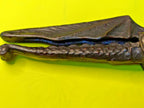 Cast metal nutcracker showing textured scale body and detailed wings – detail 11