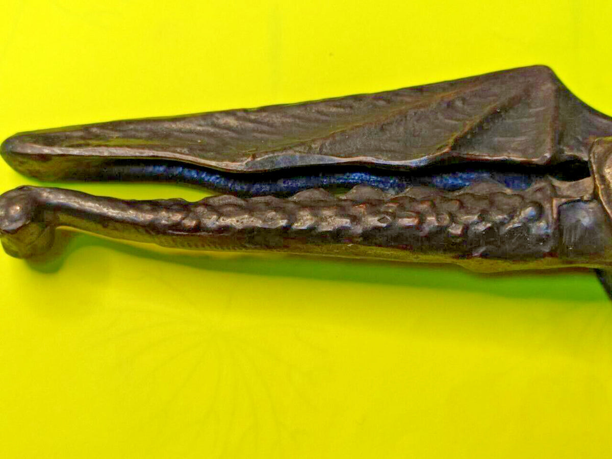 Cast metal nutcracker showing textured scale body and detailed wings – detail 11
