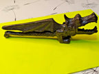 Cast metal nutcracker showing textured scale body and detailed wings