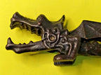 Cast metal nutcracker showing textured scale body and detailed wings – detail 5