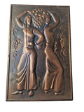 Vintage hand-hammered metal relief plaque of two women with a basket of grapes