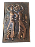 Vintage hand-hammered metal relief plaque of two women with a basket of grapes