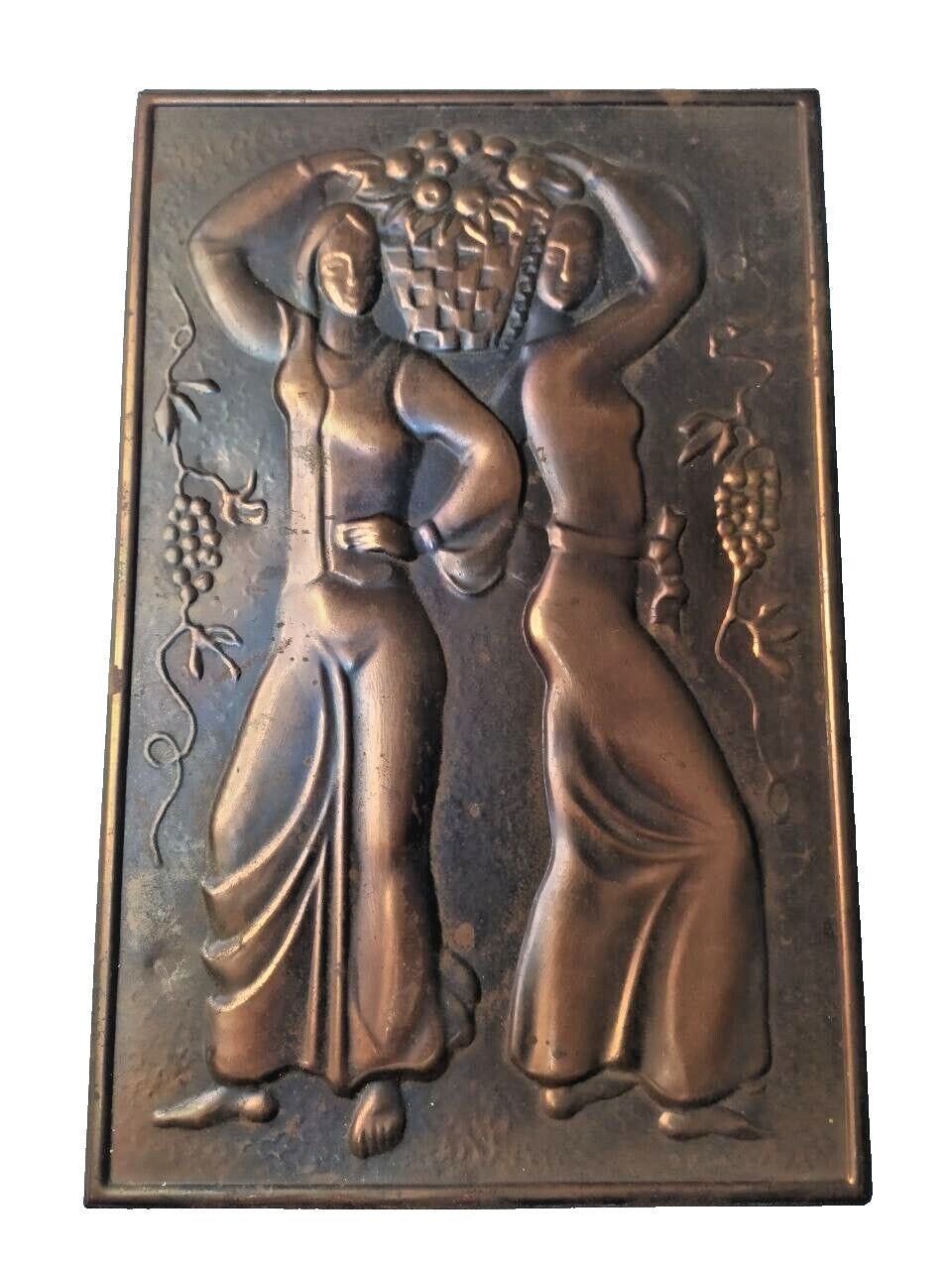 Embossed metal wall art with grapevines and two women figures